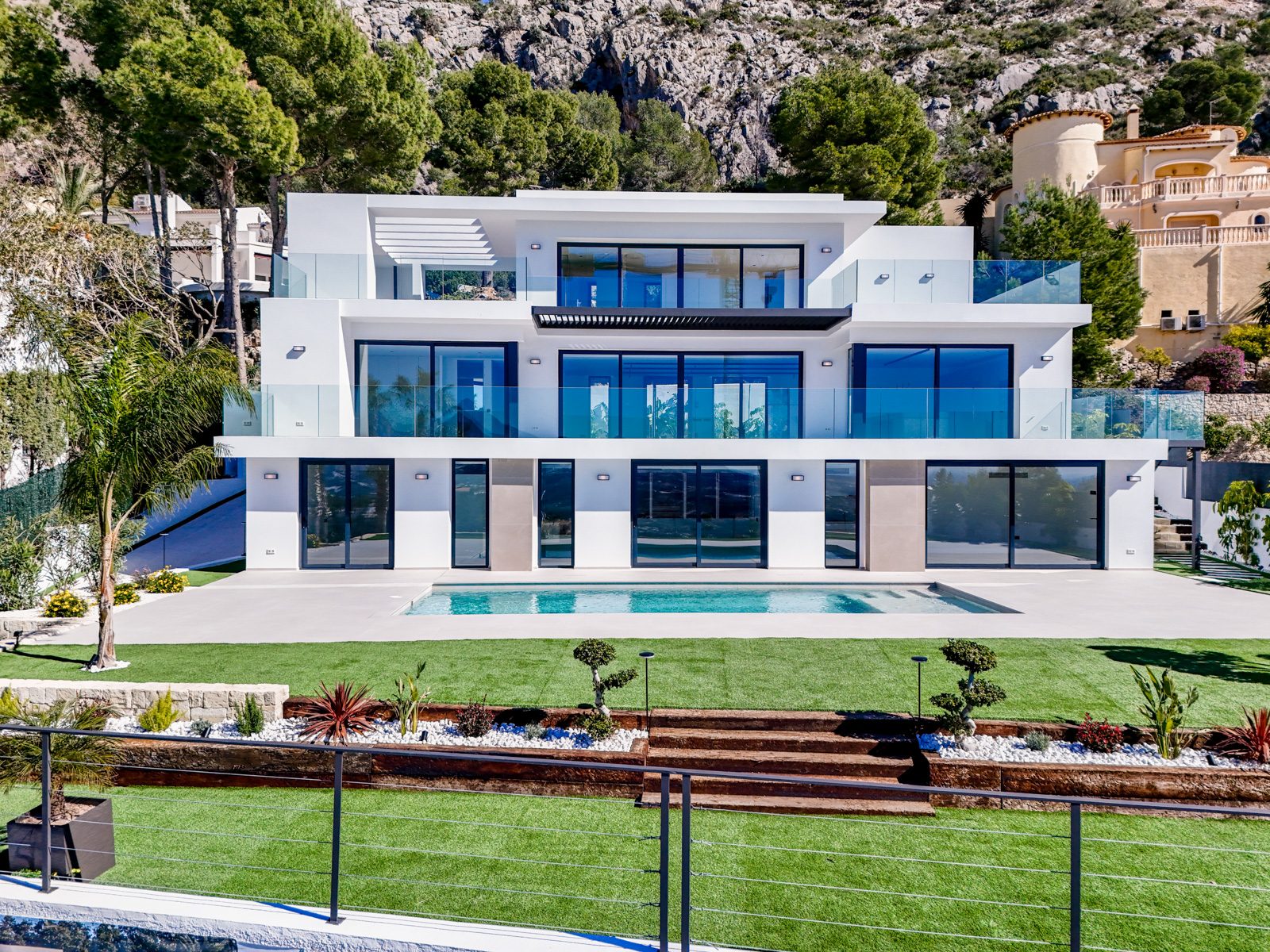 Modern villa facade, pool and landscaped garden of a 4-bedroom villa in Altea - The Estates