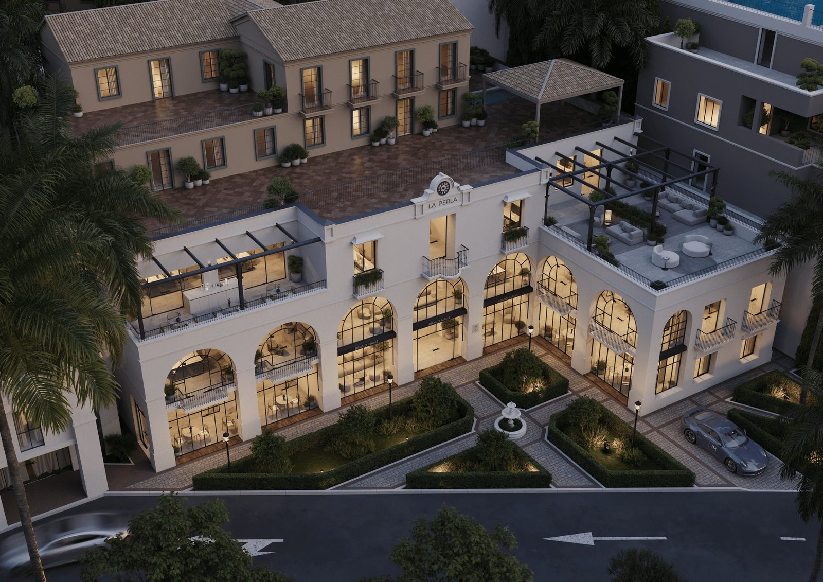 Aerial view of La Perla courtyard complex with arched storefronts, landscaped gardens and terraces in Benahavís, Málaga - The Estates