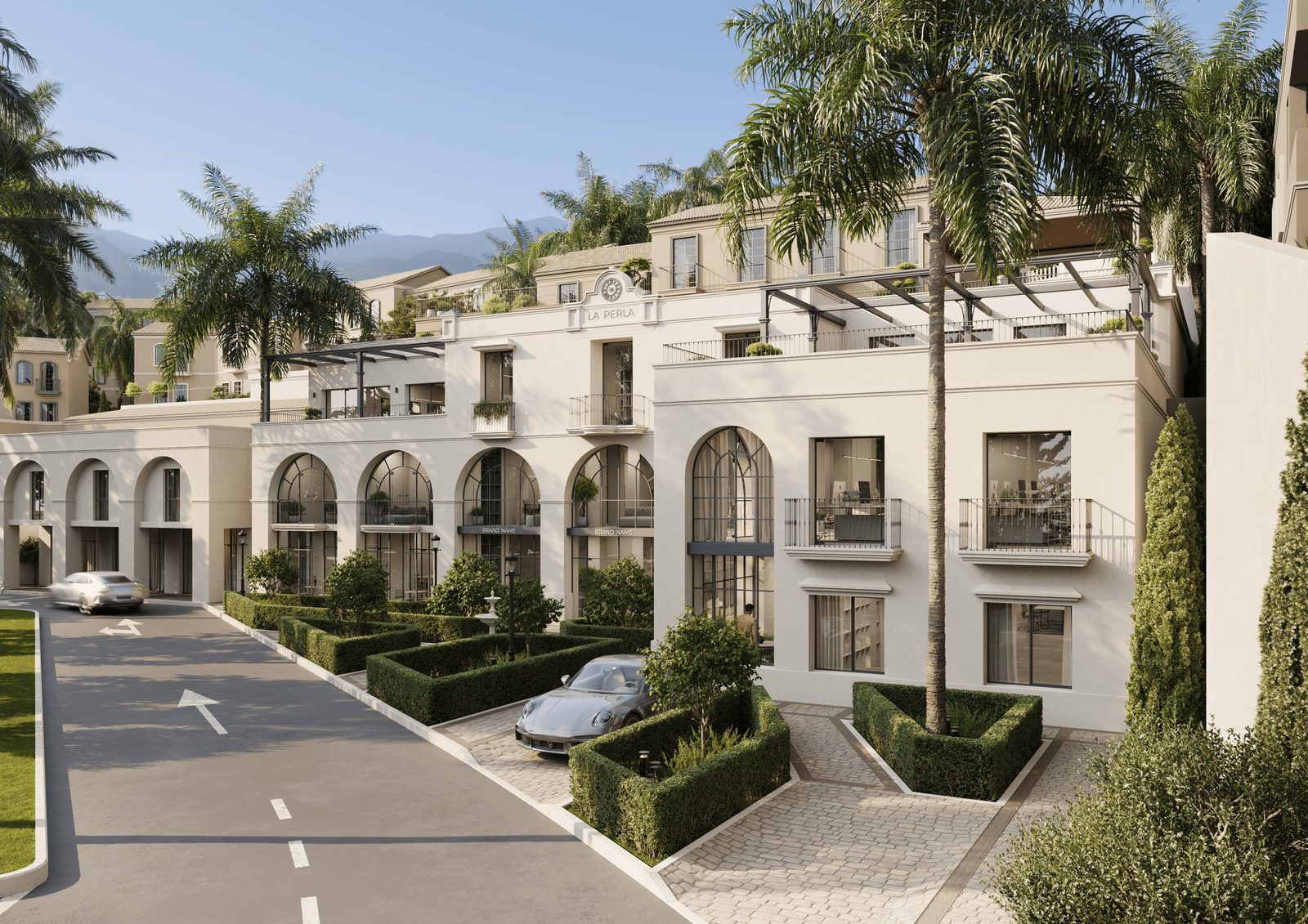 Exterior view of La Perla residences with palm trees, manicured hedges and mountain backdrop in Benahavís, Málaga -
