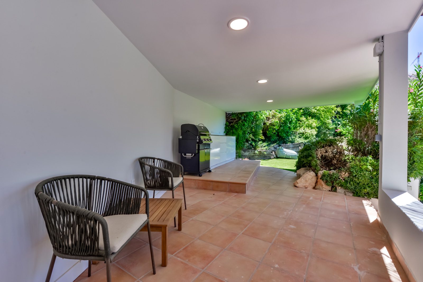 Outdoor seating area and barbecue on a terrace of a 3-bedroom villa in Altea - The Estates