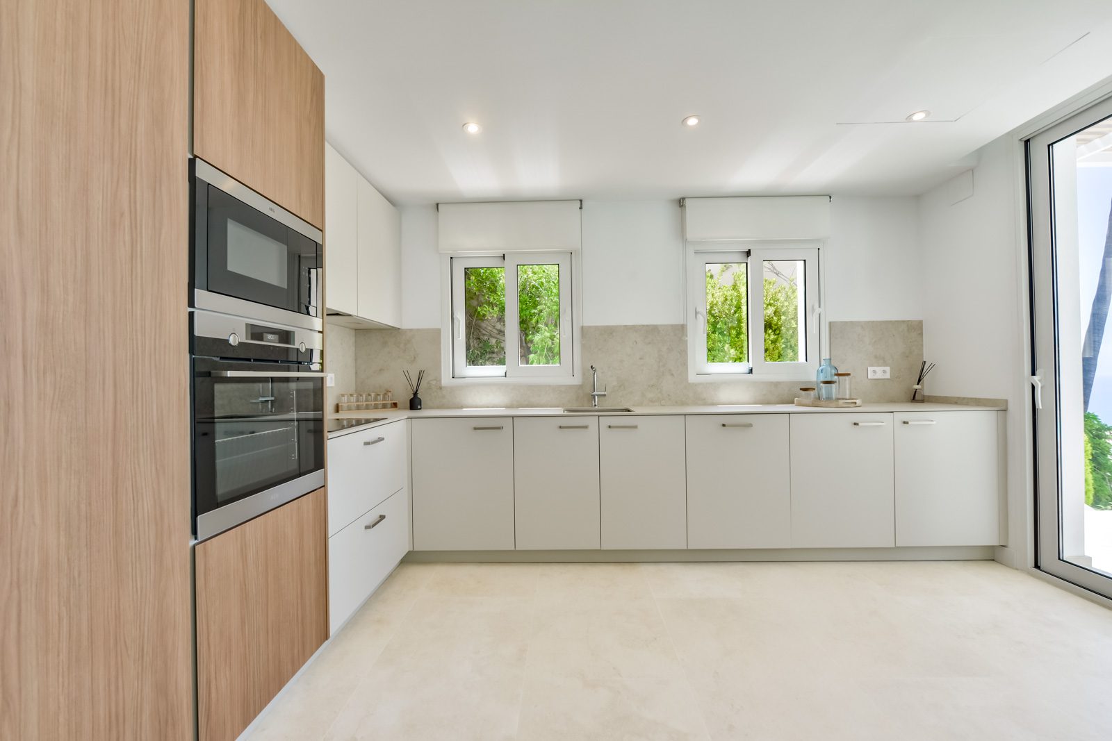 Modern kitchen with sleek cabinetry and large windows in a 3-bedroom villa in Altea - The Estates
