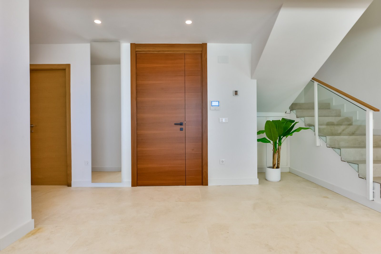 Modern interior hallway with wooden door and staircase in a 3-bedroom villa in Altea - The Estates