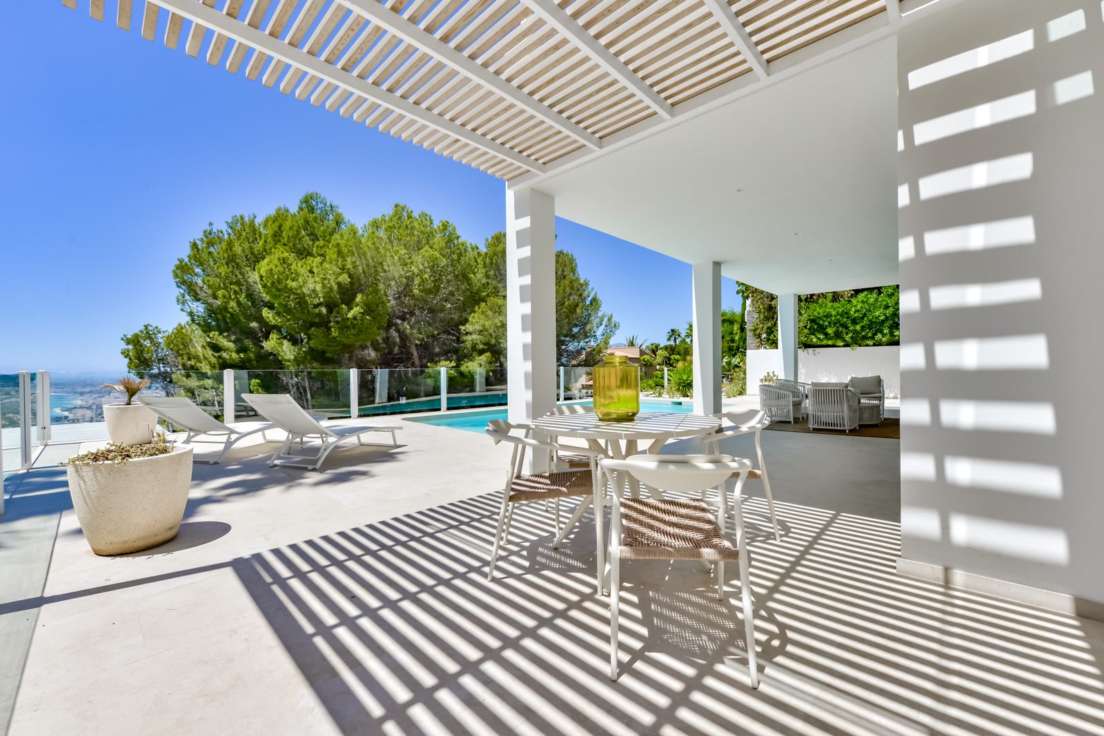 A stylish outdoor dining area and lounge space with sea views at a 3-bedroom villa in Altea - The Estates
