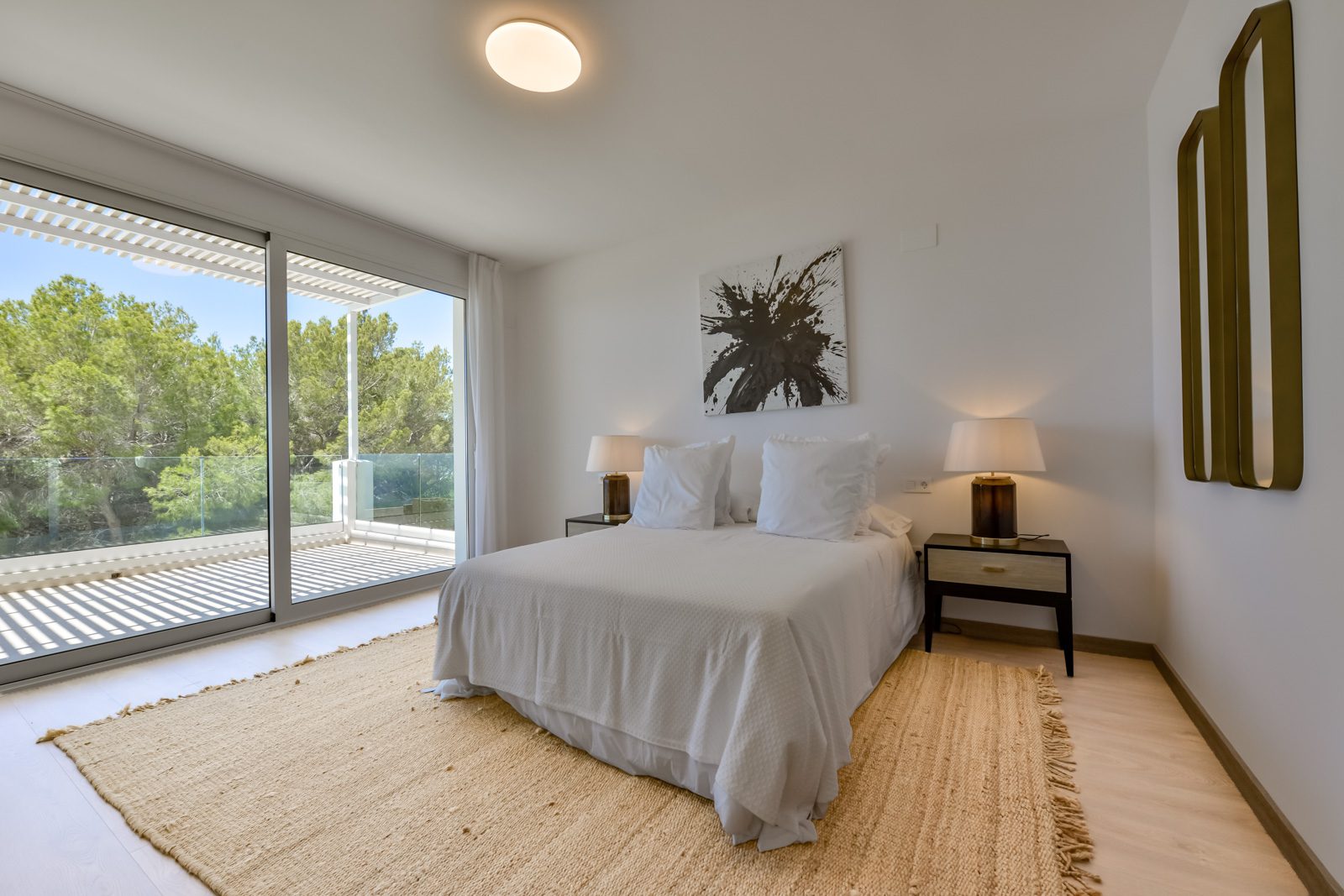 A bright bedroom with large windows and sea views in a 3-bedroom villa in Altea - The Estates