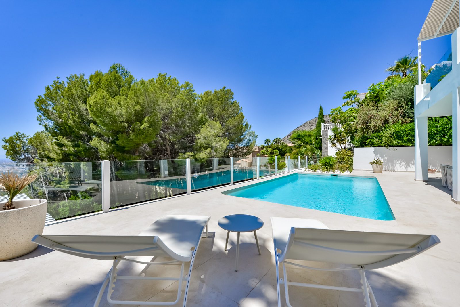 A beautiful pool area with sun loungers at a 3-bedroom villa in Altea - The Estates