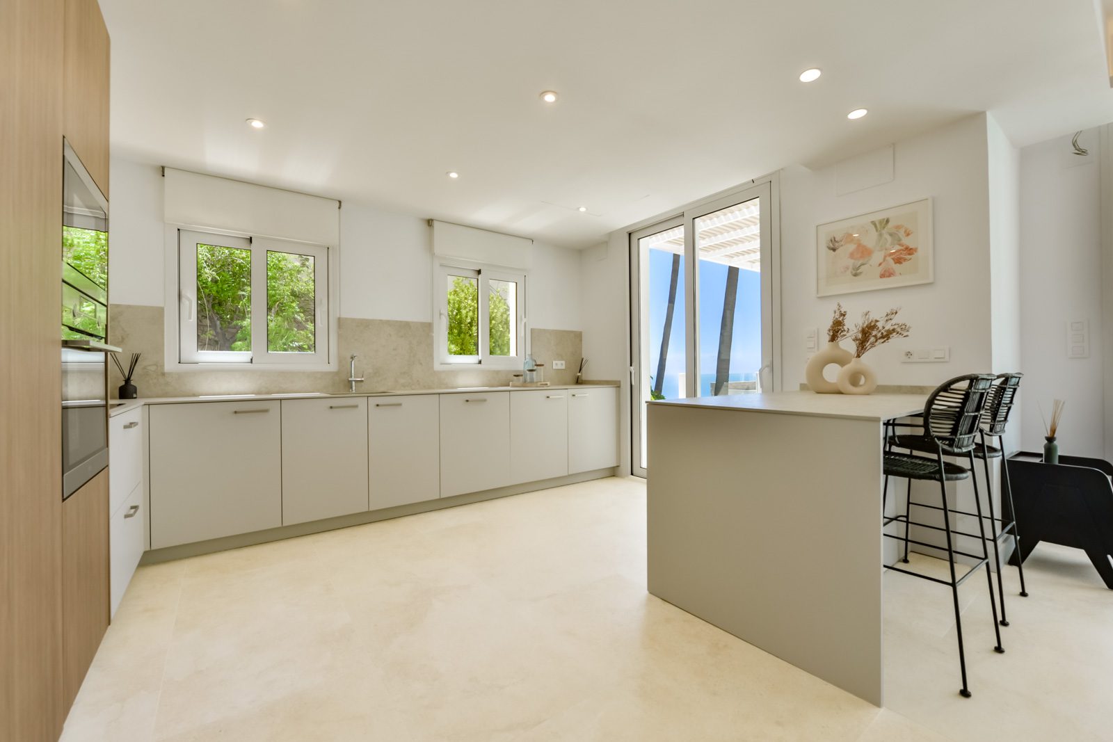 A modern kitchen with island seating in a 3-bedroom villa in Altea - The Estates