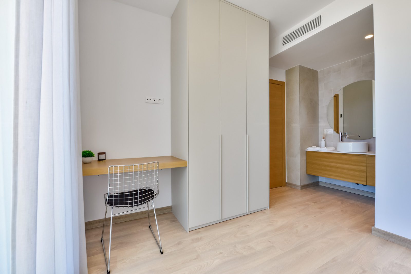 A modern bedroom with built-in wardrobe and desk in a 3-bedroom villa in Altea - The Estates
