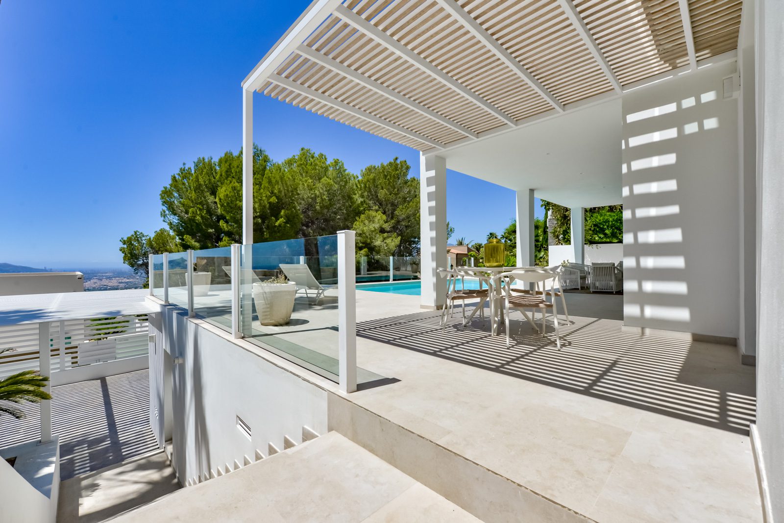 A covered terrace with seating and a pool overlooking the sea at a 3-bedroom villa in Altea - The Estates