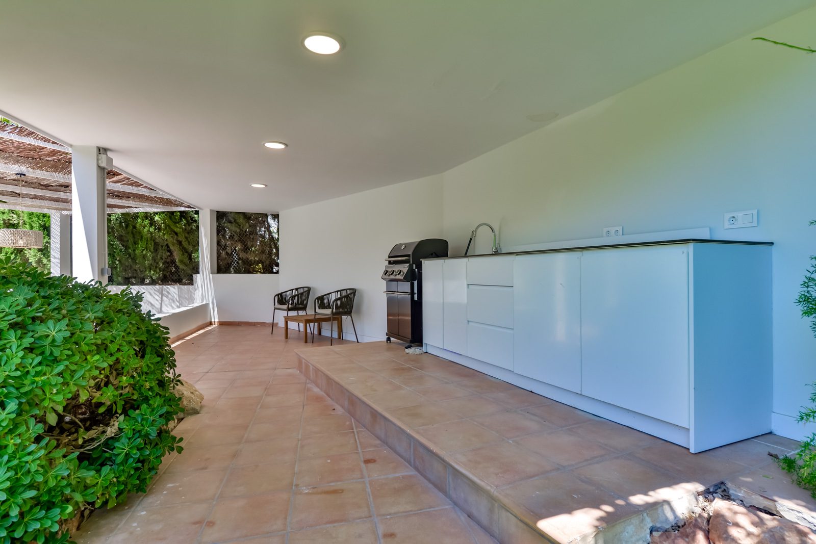 Outdoor kitchen and seating area on a terrace of a 3-bedroom villa in Altea - The Estates