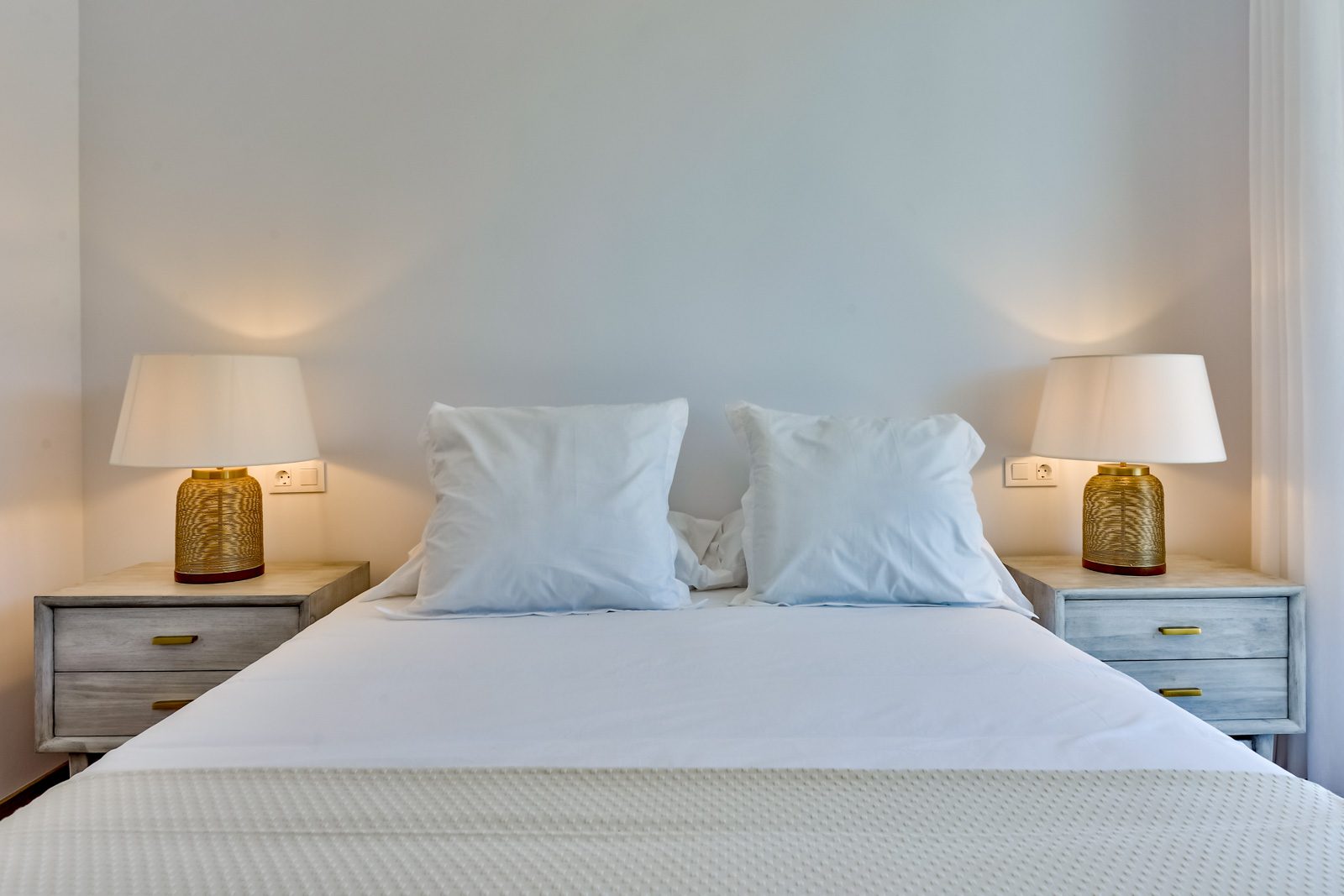 A stylish bedroom with bedside lamps and cushions in a 3-bedroom villa in Altea - The Estates