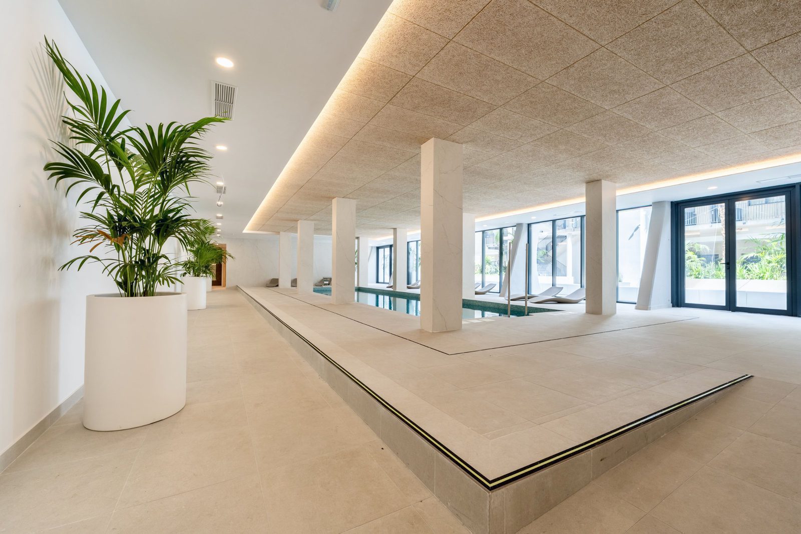 A bright interior with a pool and large windows in a 3-bedroom apartment in Alfaz del Pi - The Estates