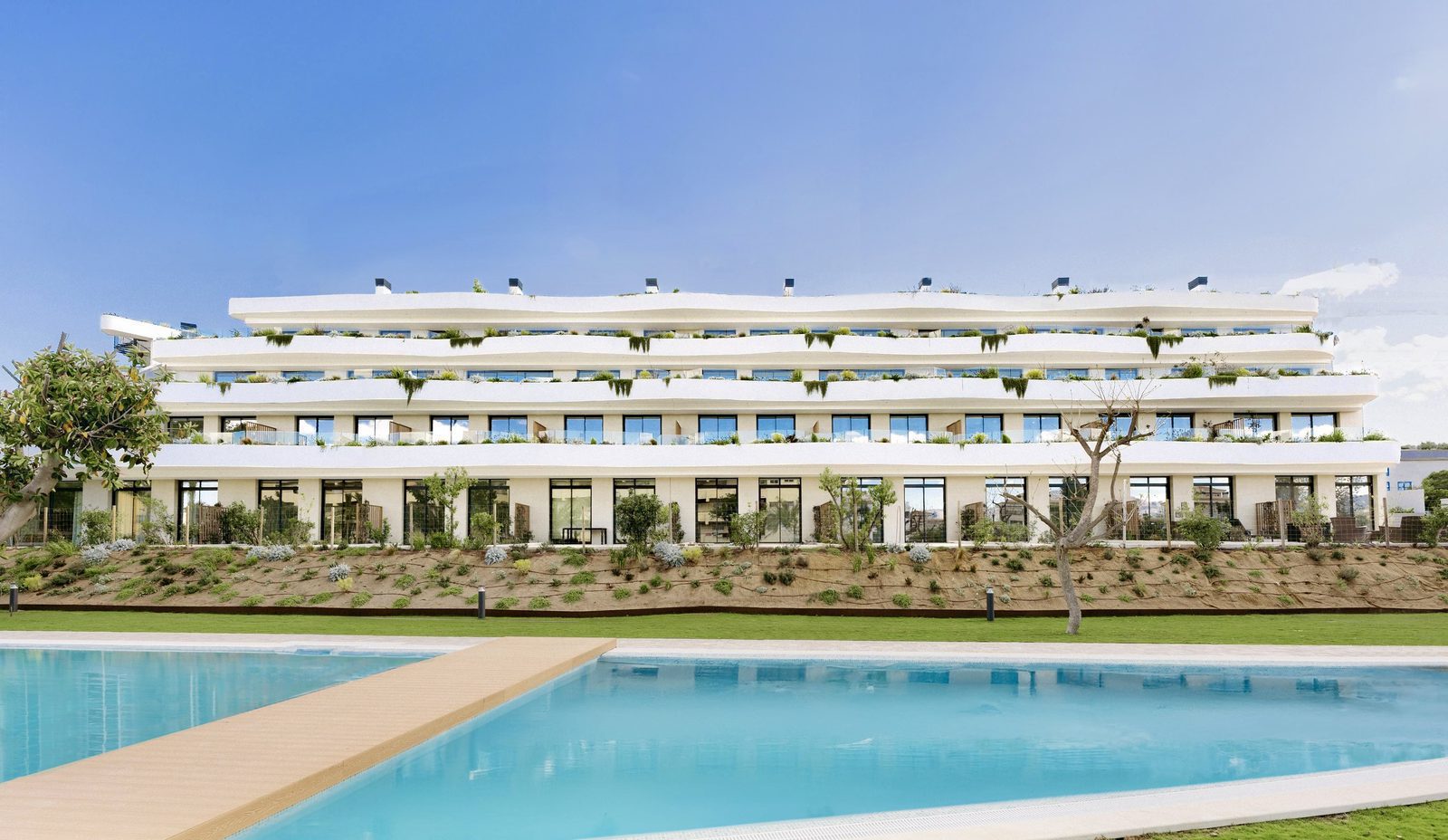 Exterior view of a 3-bedroom apartment building with a pool in Alfaz del Pi - The Estates