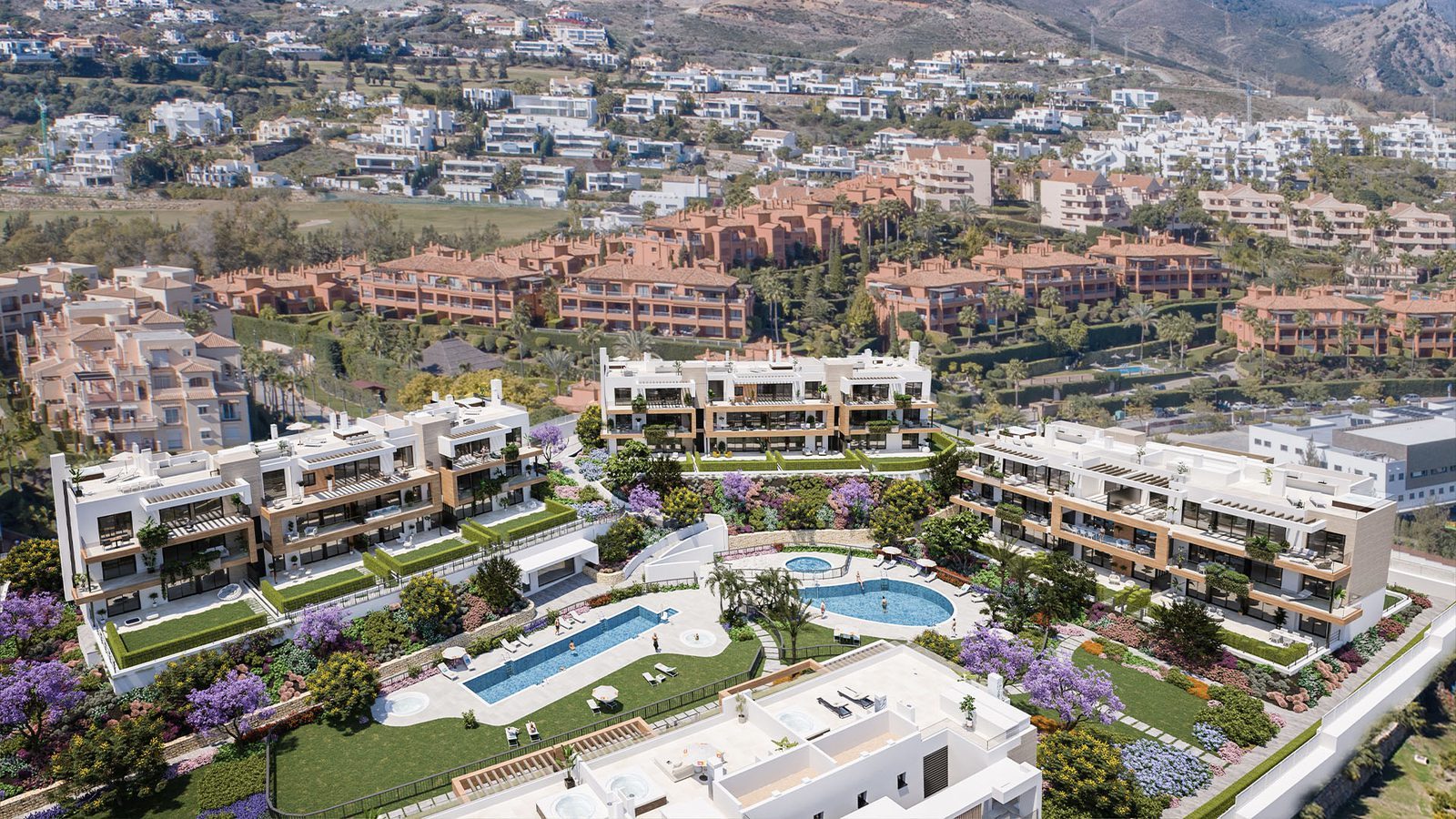 Aerial view of landscaped residences, pools and golf course of a 3-bedroom apartment in Estepona - The Estates