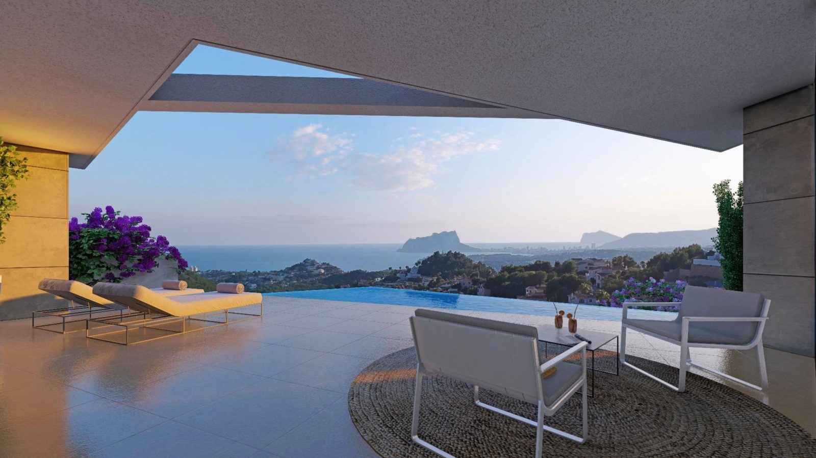 Infinity pool terrace with loungers and seating overlooking panoramic sea views at a 3-bedroom villa in Benitachell - The Estates