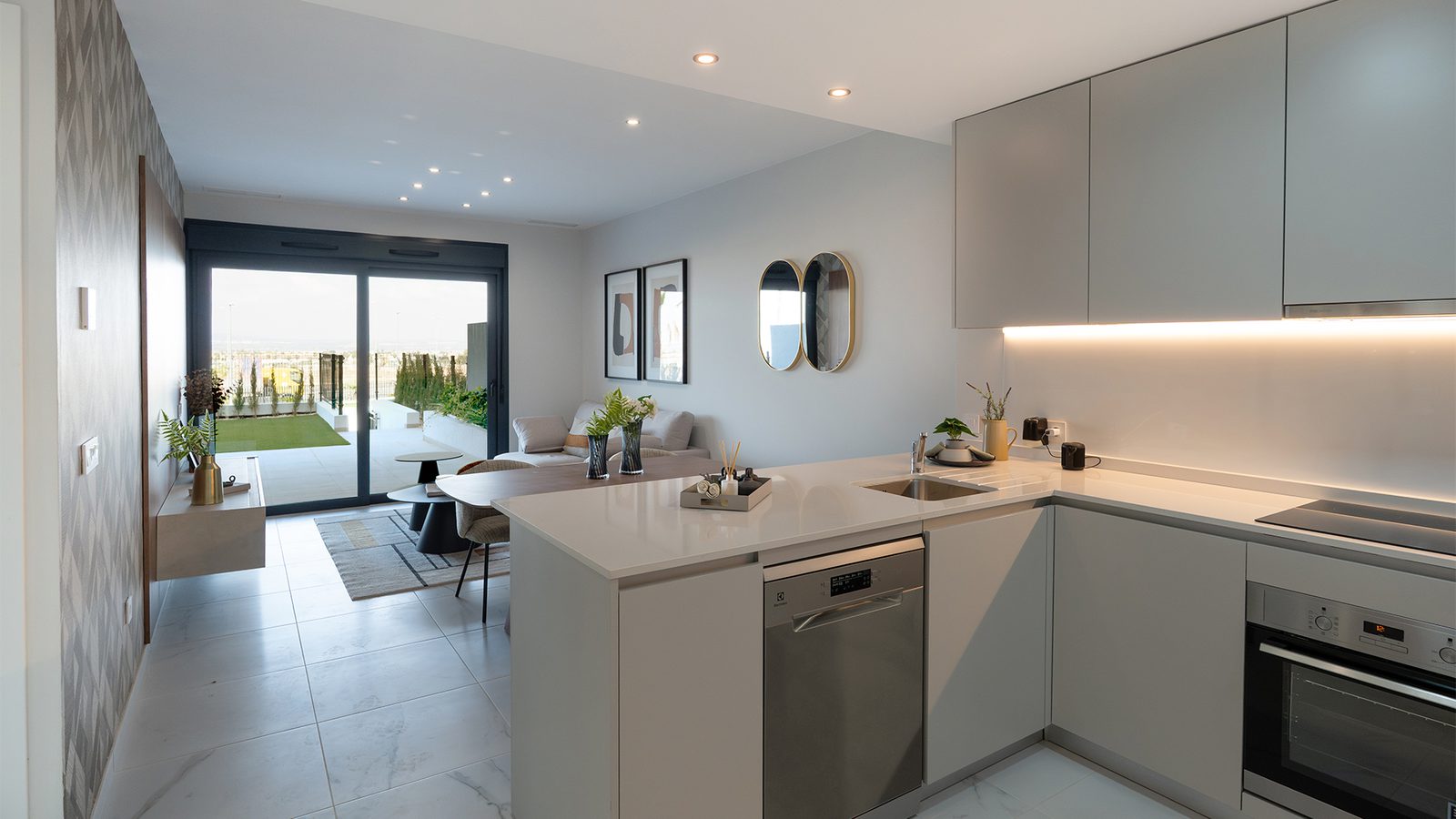 Modern kitchen with island and balcony view in a 3-bedroom semi-detached in Torrevieja - The Estates
