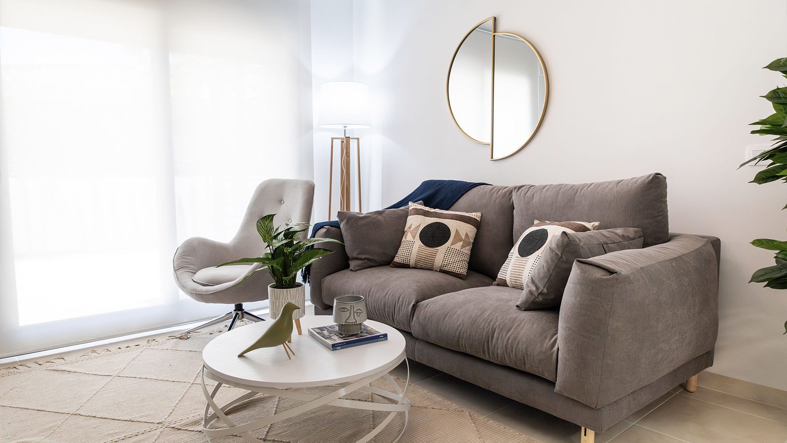 Bright living room with grey sofa, armchair, coffee table and contemporary decor in a 3-bedroom villa in Busot, zona Bonalba Golf - The Estates