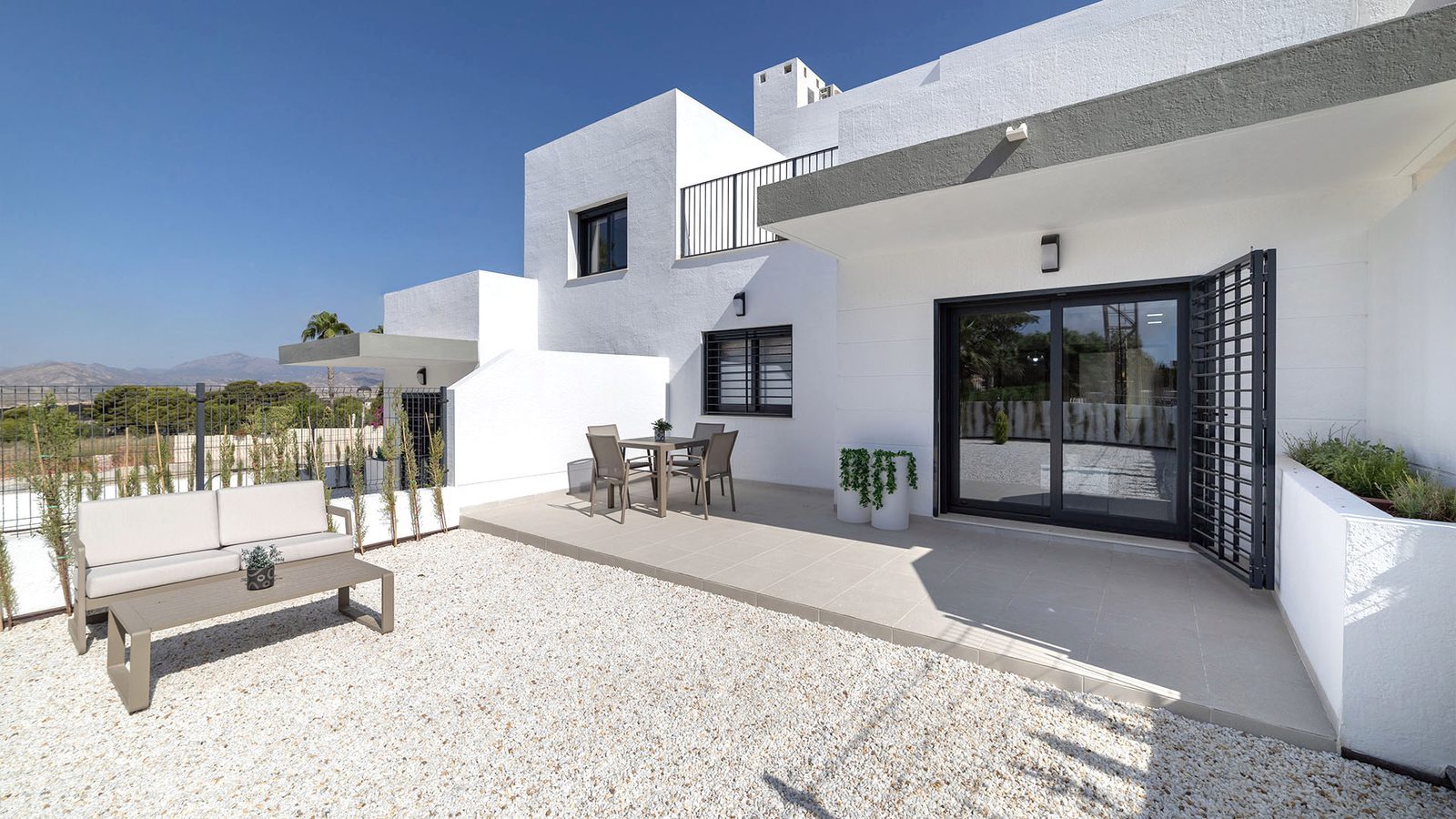 Sunlit terrace with outdoor seating and mountain views of a 3-bedroom villa in Busot, zona Bonalba Golf - The Estates