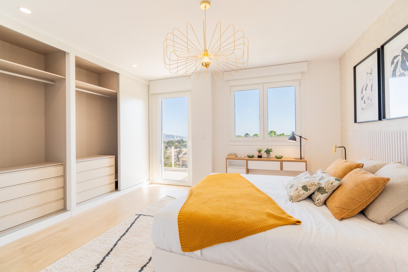 A bright bedroom with built-in wardrobes and a view of the city in a 4-bedroom townhouse in La Nucía - The Estates