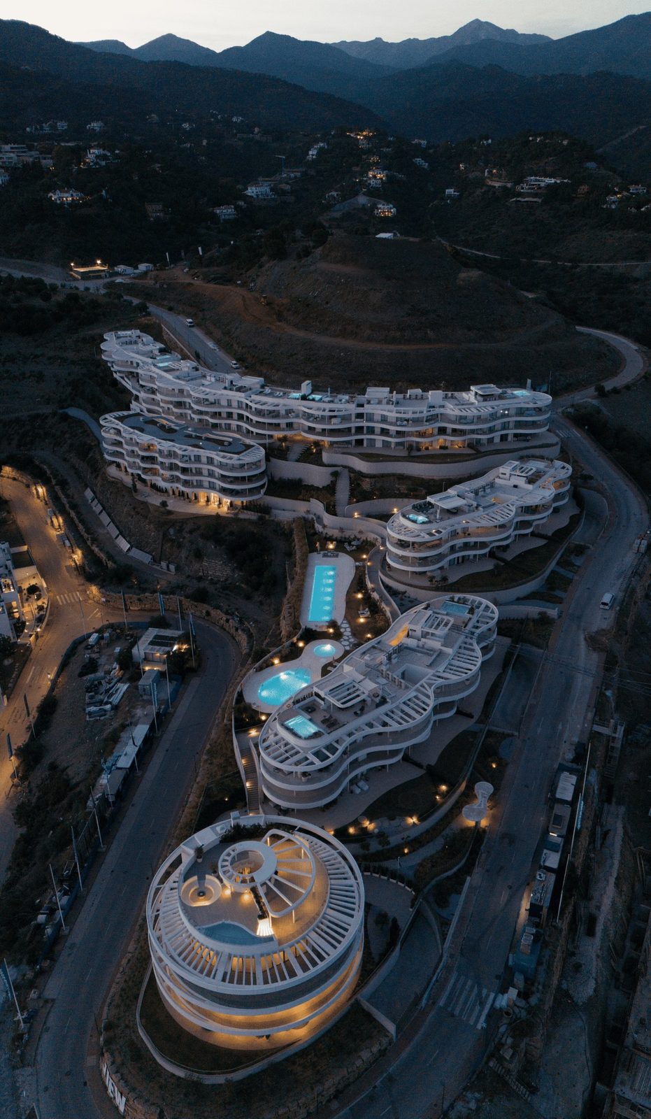 Aerial view of a luxury resort with pools and mountain views in Benahavís, Málaga, from a 4-bedroom penthouse - The Estates