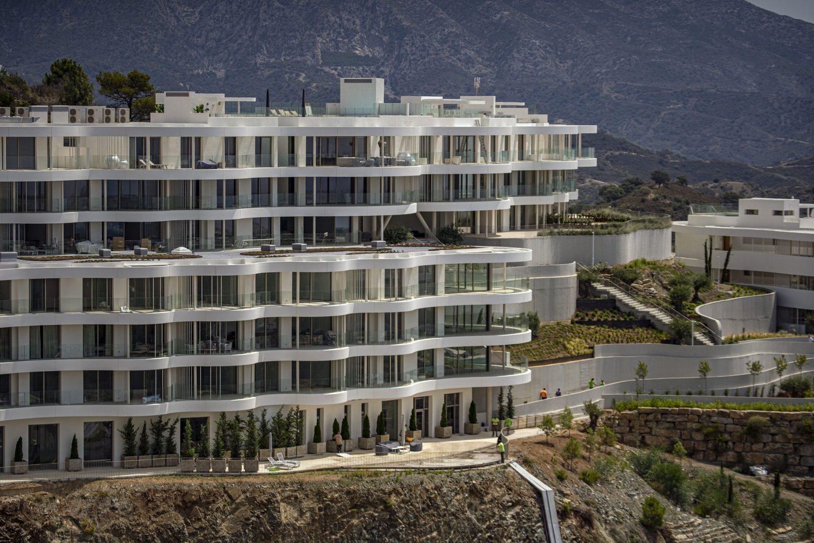 Modern white penthouse development with terraces and mountain views in Benahavís, Málaga — of a 4-bedroom penthouse in Málaga - The Estates
