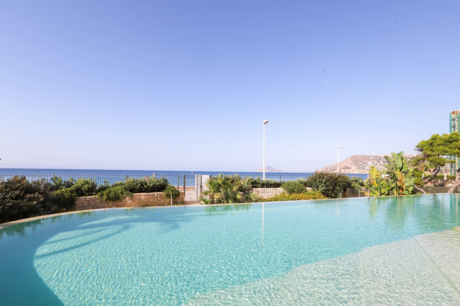 A pool with sea and garden views from a 4-bedroom apartment in Calpe - The Estates