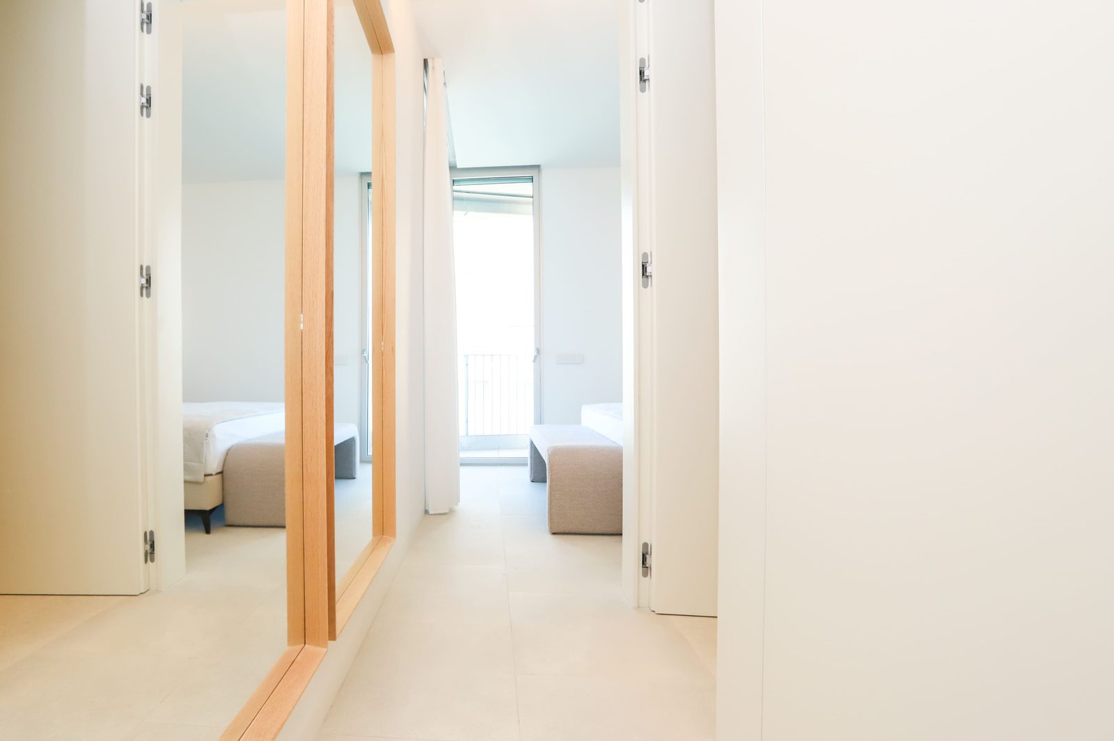 Modern built-in wardrobes in a bright hallway of a 4-bedroom apartment in Calpe - The Estates