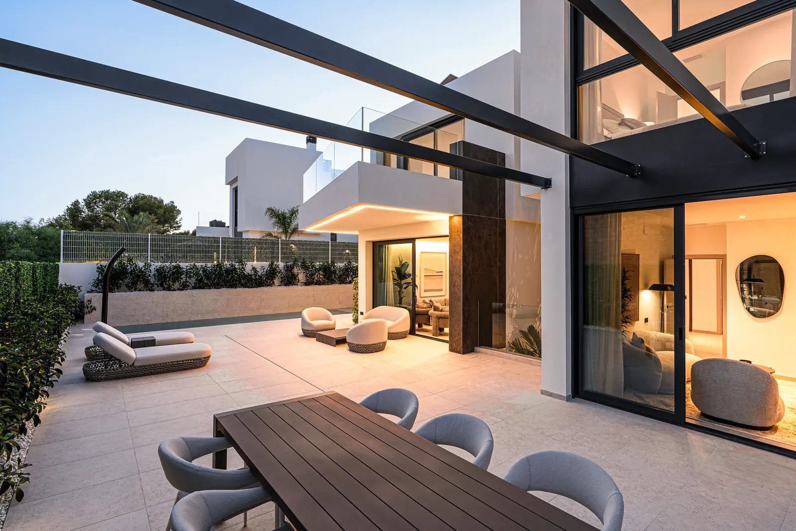 Stylish outdoor living area with a dining set and lounge seating on a 4-bedroom villa in La Nucia - The Estates