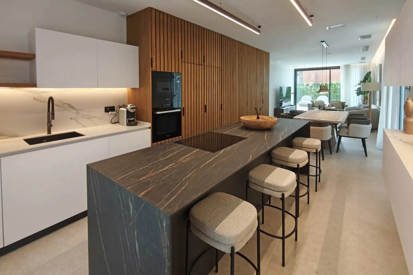 Modern kitchen with a breakfast bar and dining area in a 4-bedroom villa in La Nucia - The Estates
