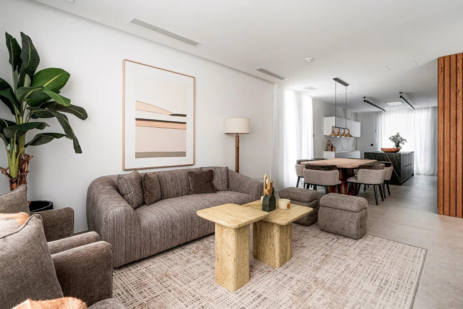 Stylish living room with modern decor and open kitchen in a 4-bedroom villa in La Nucia - The Estates