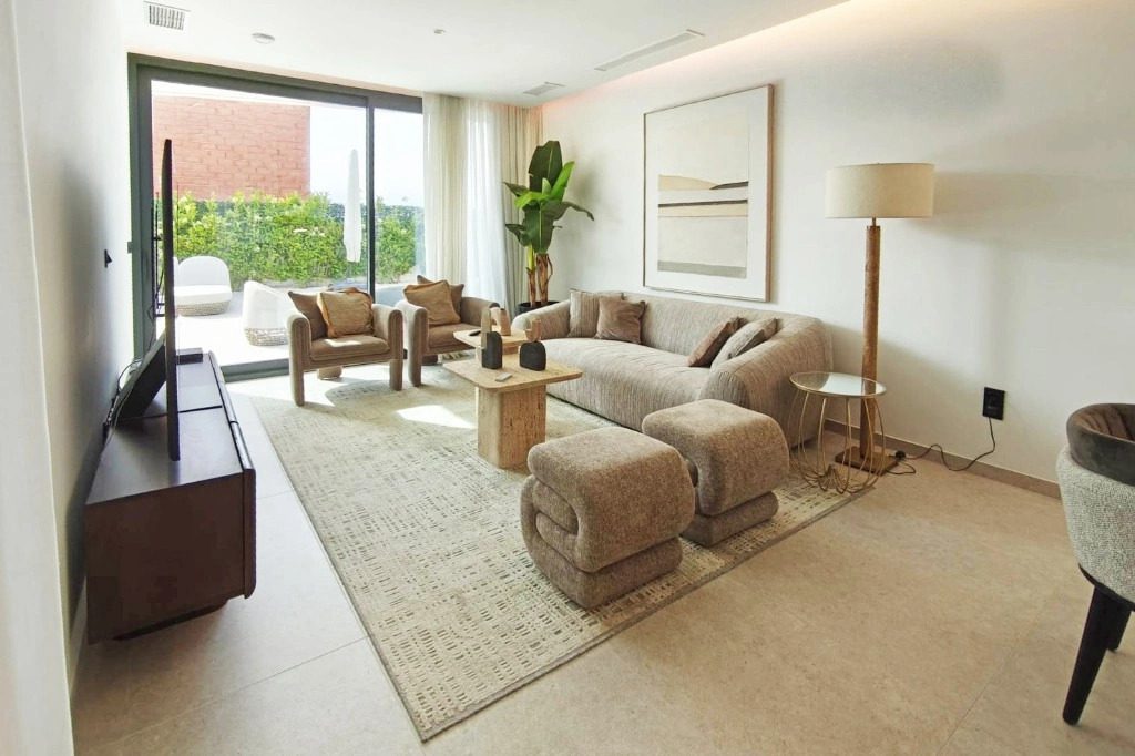 Stylish living room with patio access of a 4-bedroom villa in La Nucia - The Estates