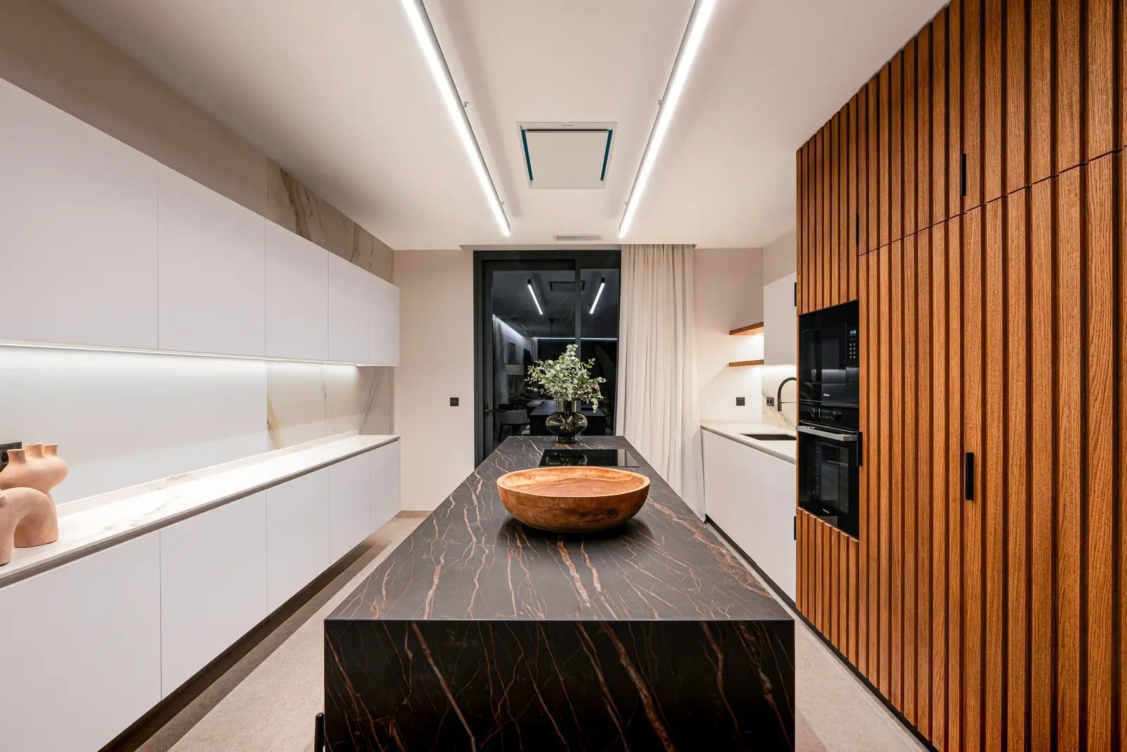 A modern kitchen with a large island in a 4-bedroom villa in La Nucia - The Estates