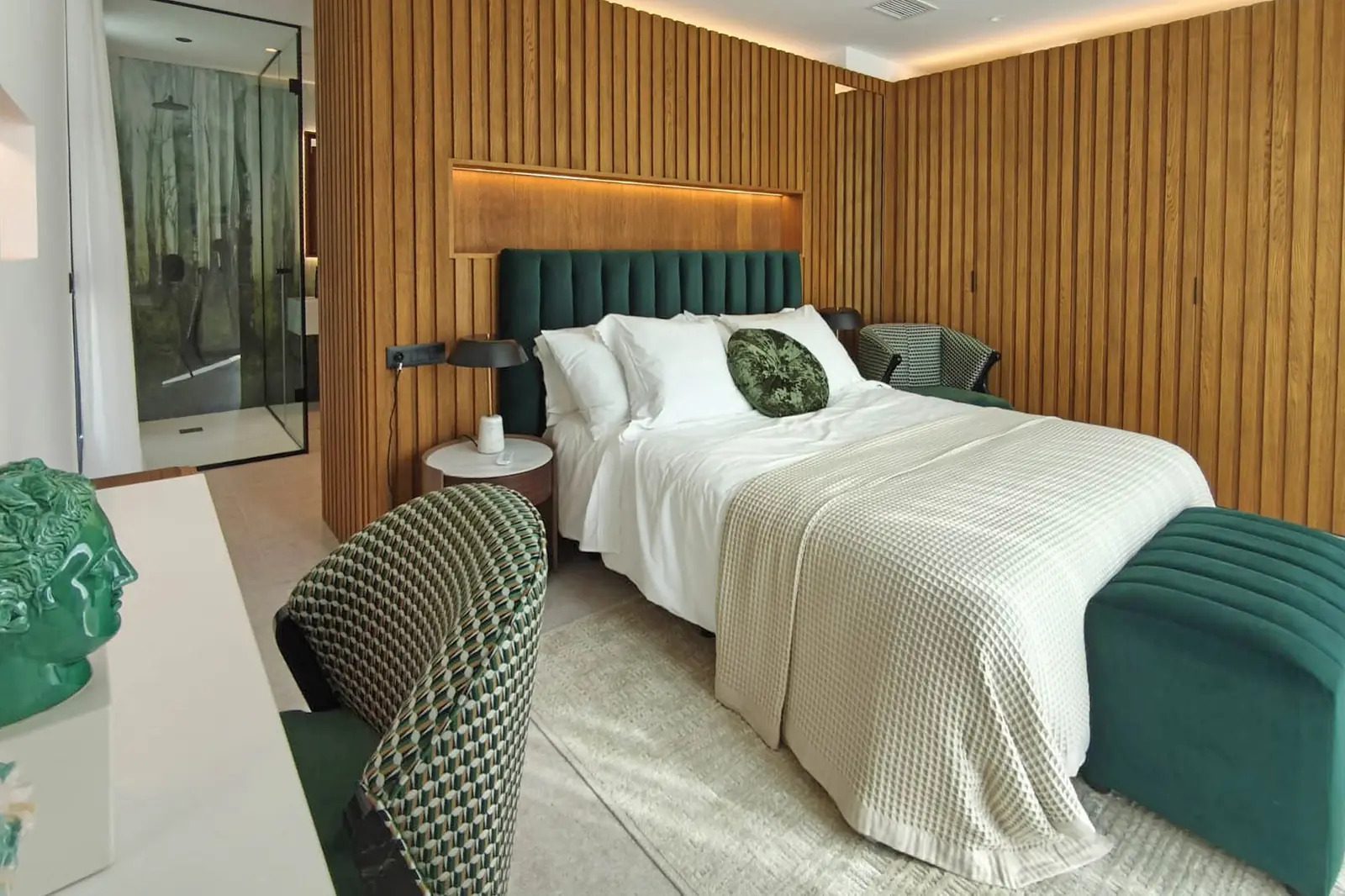 A stylish bedroom with a large bed and modern decor in a 4-bedroom villa in La Nucia - The Estates