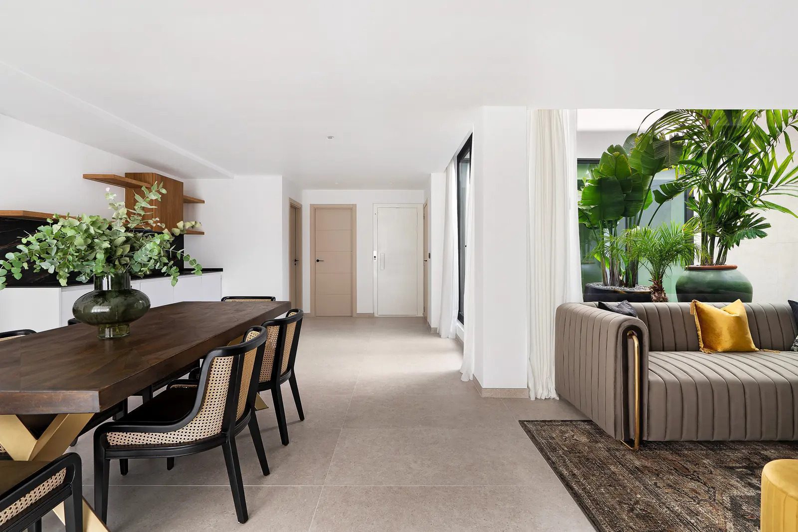 Stylish living and dining area with lush greenery in a 4-bedroom villa in La Nucia - The Estates