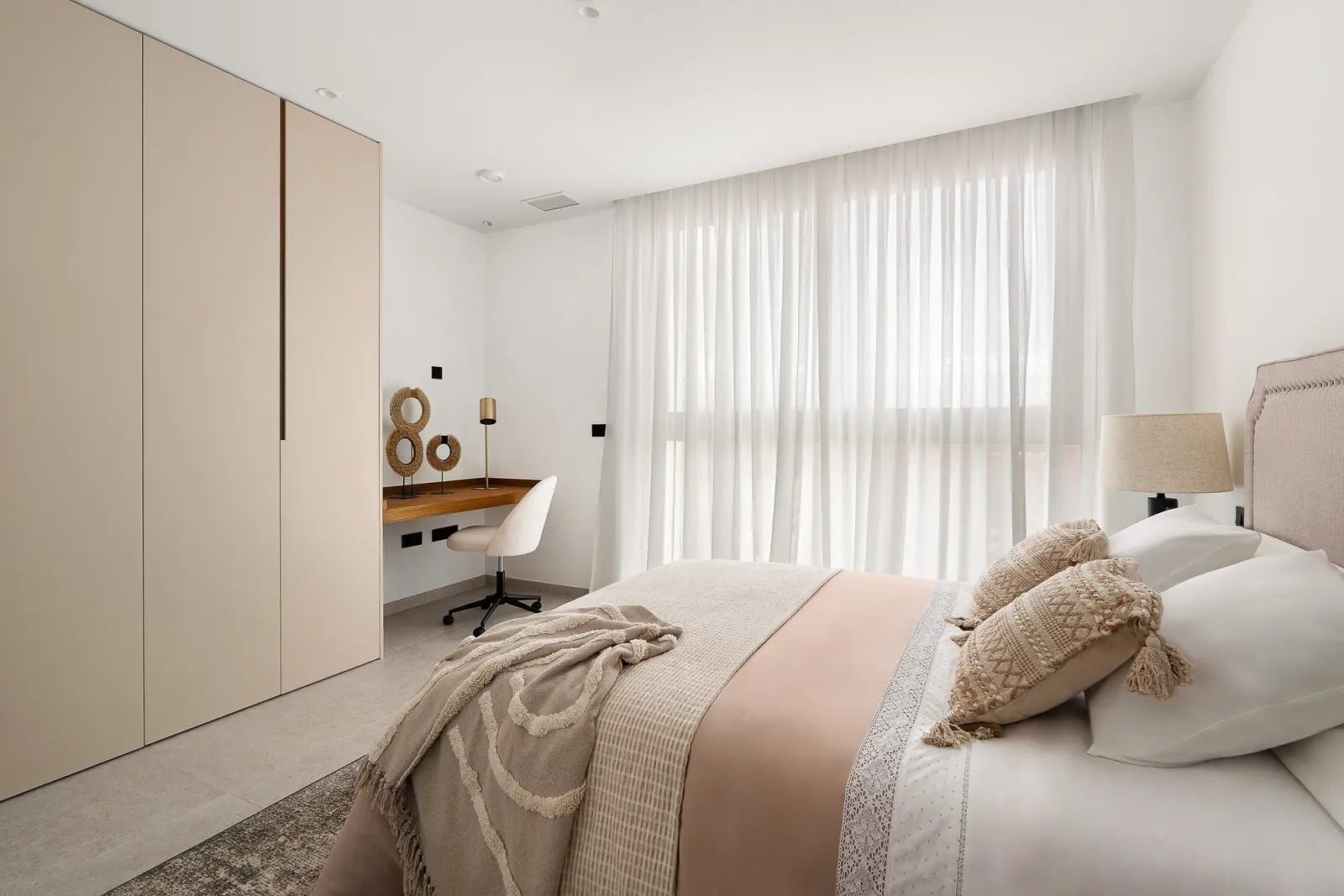 A stylish bedroom with built-in storage and a desk in a 4-bedroom villa in La Nucia - The Estates