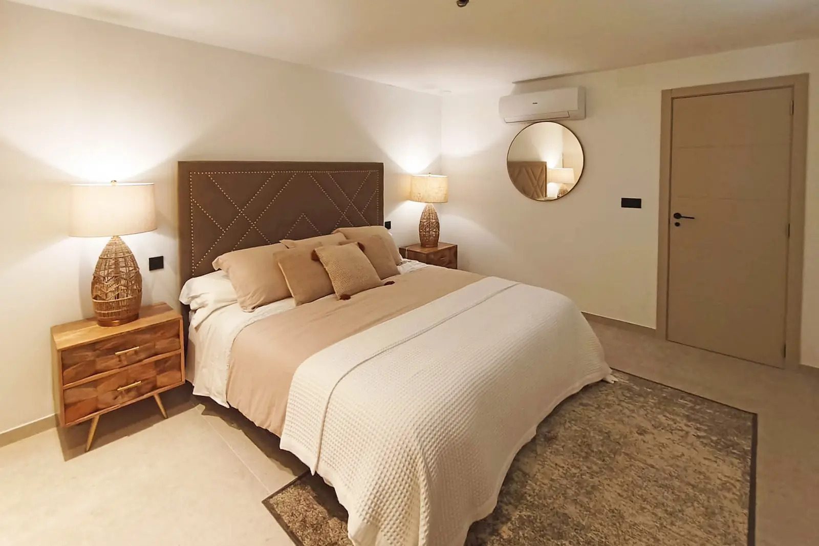 A stylish bedroom with a decorative headboard in a 4-bedroom villa in La Nucia - The Estates