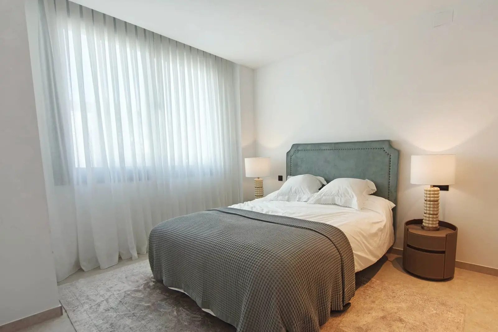 A stylish bedroom with a comfortable bed and elegant decor in a 4-bedroom villa in La Nucia - The Estates