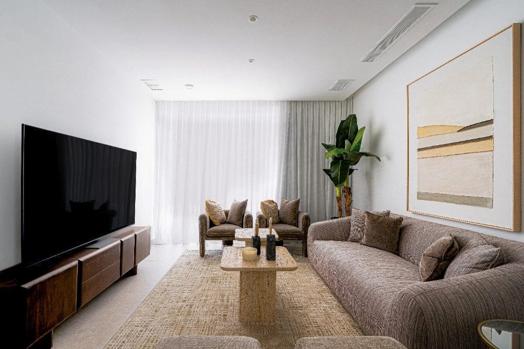 Stylish living room with a large TV and comfortable seating in a 4-bedroom villa in La Nucia - The Estates