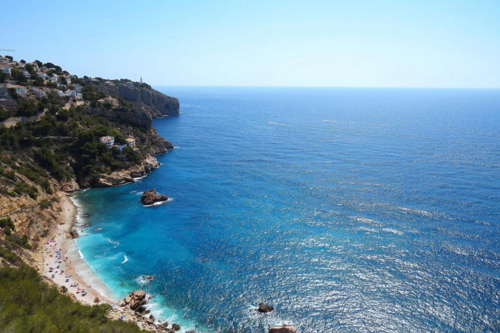 Coastal cove with turquoise water, cliffs and beach, a view from a 4