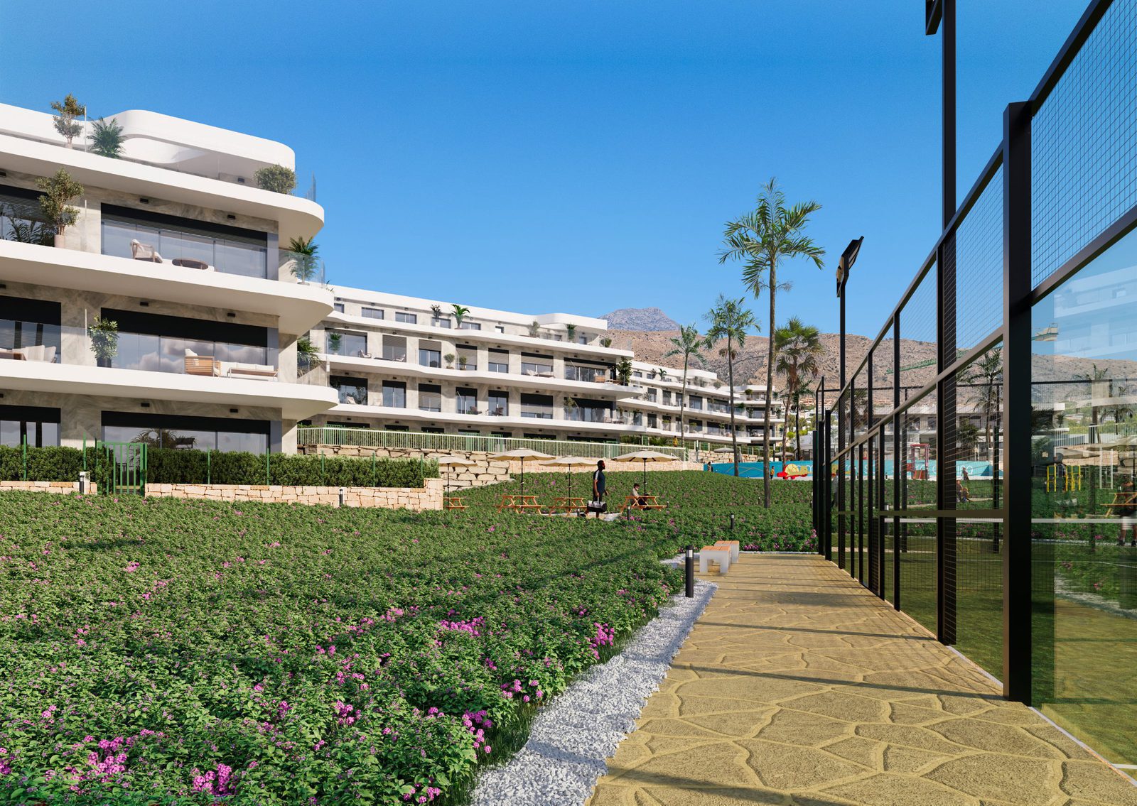 Exterior view of a 2-bedroom apartment complex with gardens and mountain views in Finestrat - The Estates