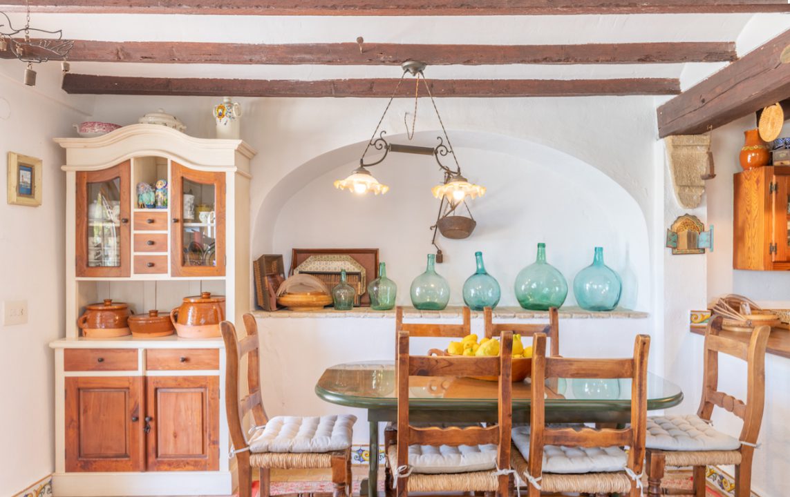 A charming dining area with rustic decor and views of decorative pottery - The Estates