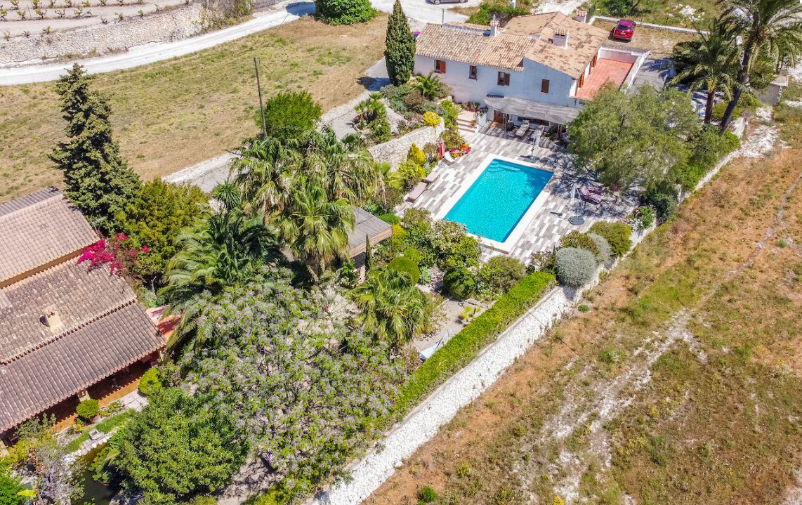 Aerial view of a beautiful finca with a pool and gardens in Moraira - The Estates