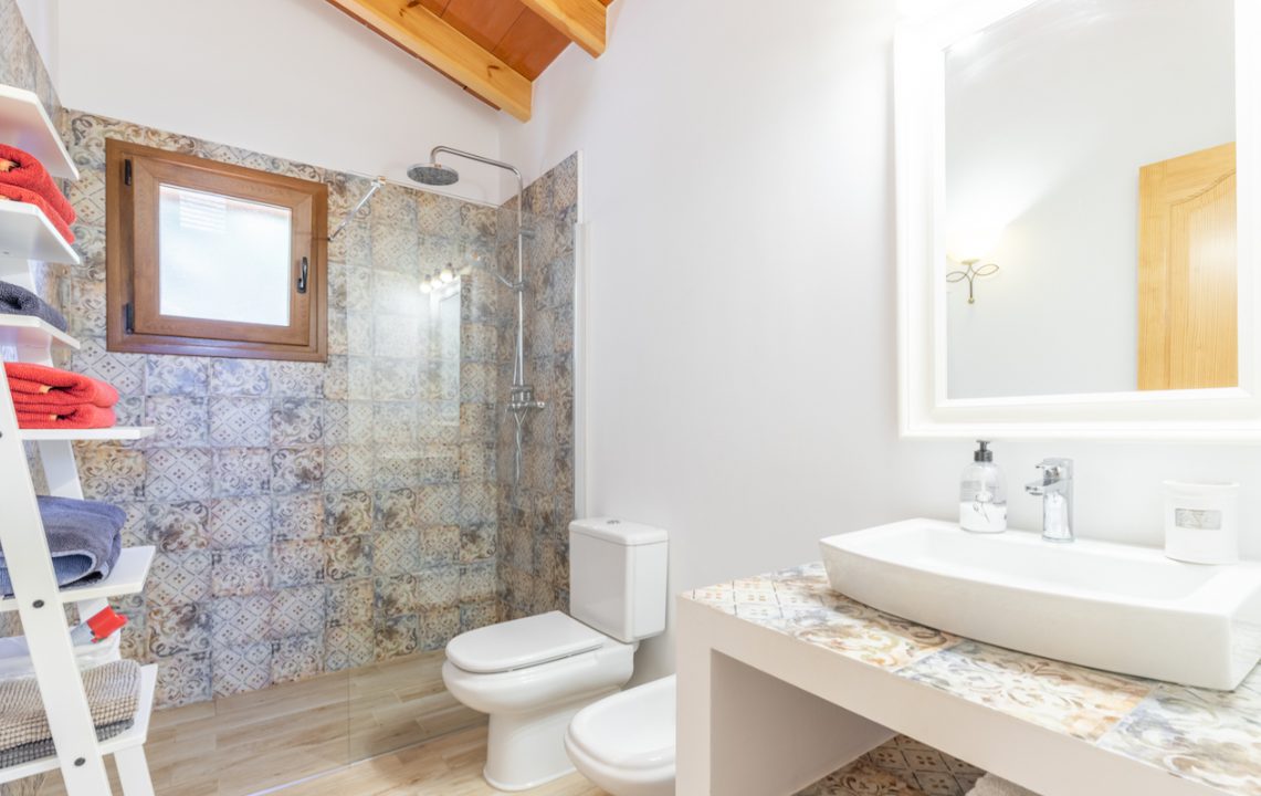A stylish bathroom with patterned tiles and modern fixtures in an 8-bedroom finca in Moraira - The Estates