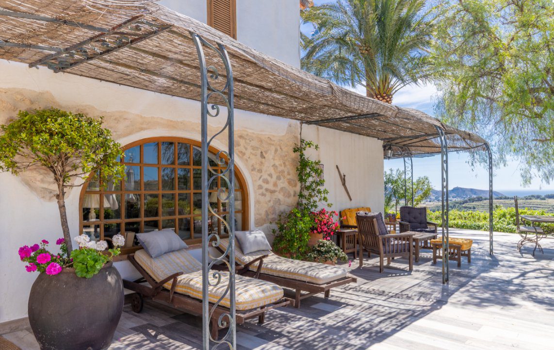 Relaxing outdoor lounge area with arched windows on an 8-bedroom finca in Moraira - The Estates