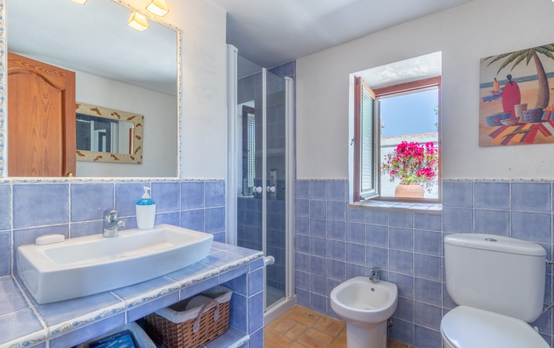 A bright bathroom with a shower, sink, and toilet in an 8-bedroom finca in Moraira - The Estates