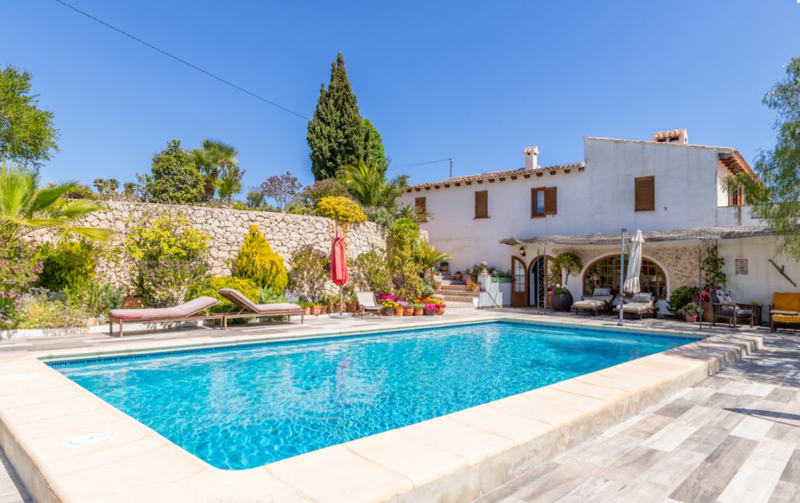 A beautiful pool area with lush gardens surrounding an 8-bedroom finca in Moraira - The Estates