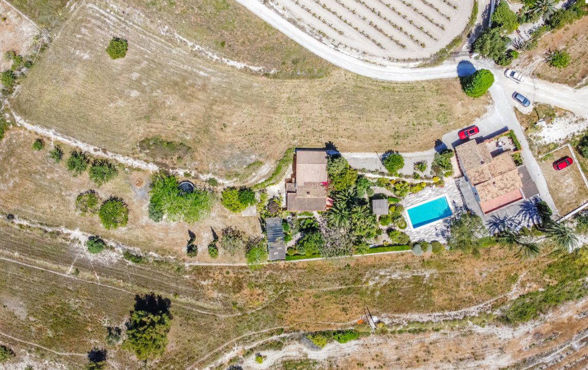 Aerial view of the expansive grounds and pool of an 8-bedroom finca in Moraira - The Estates