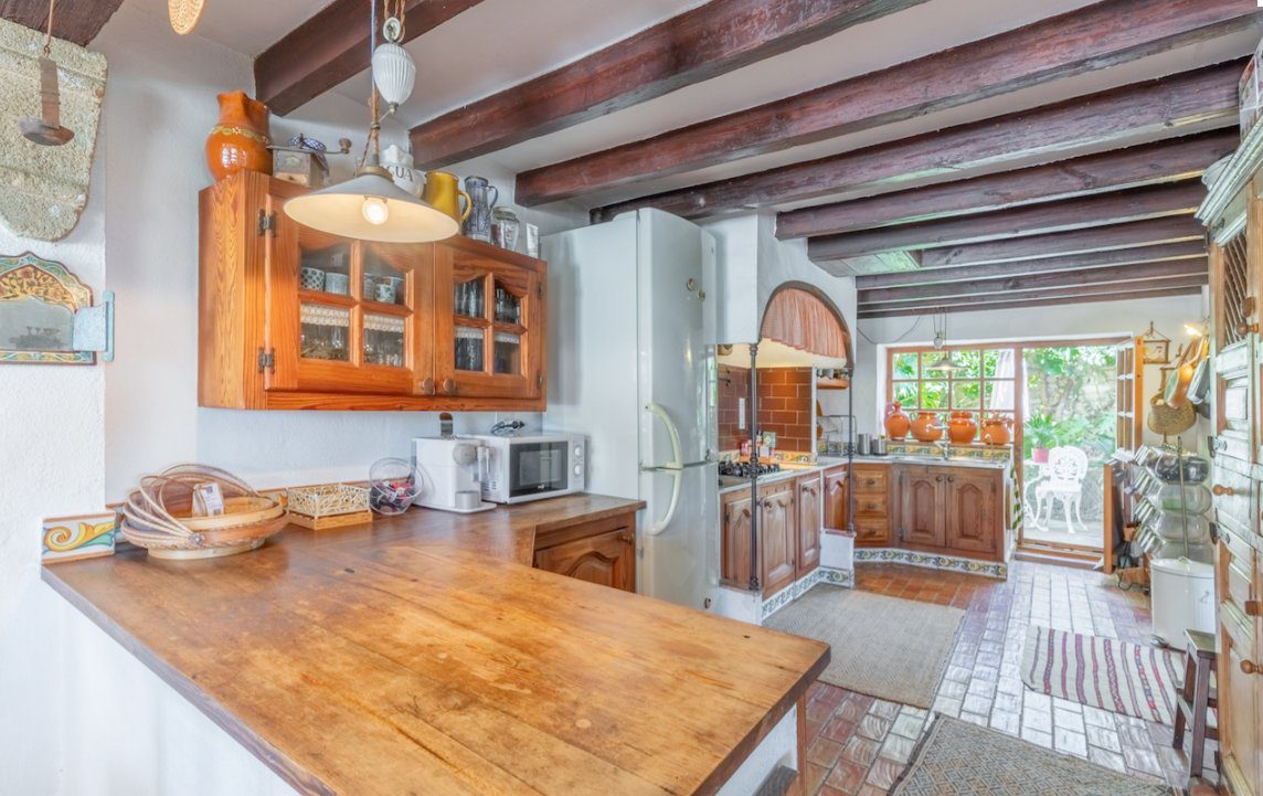 A well-equipped kitchen with exposed beams in an 8-bedroom finca in Moraira - The Estates