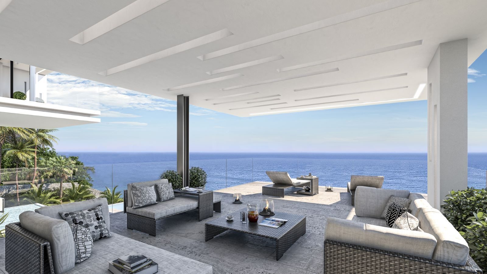 Covered terrace with outdoor seating and panoramic sea views of a