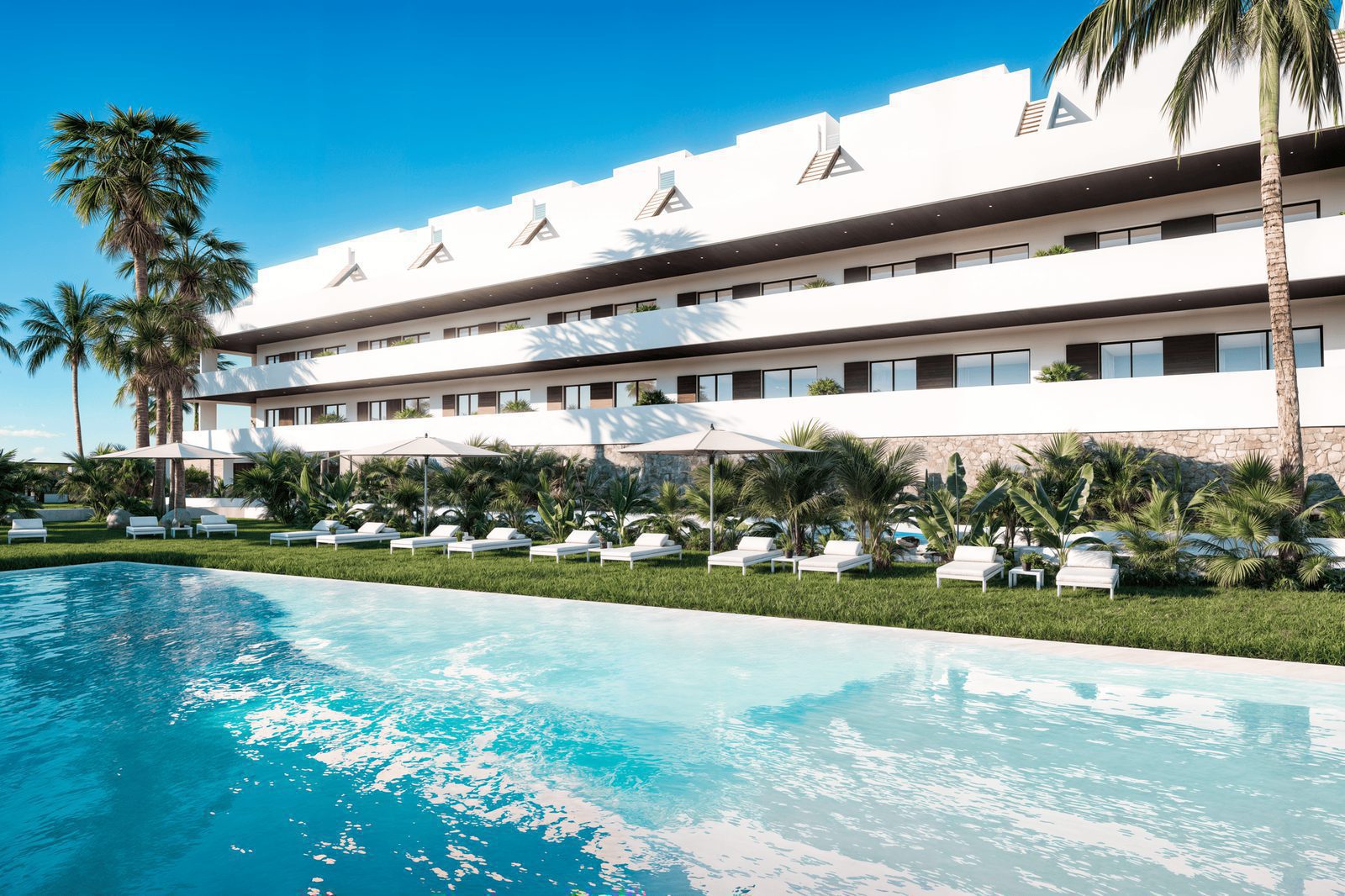 Exterior view of a modern 2-bedroom penthouse with a pool and palm trees in Finestrat - The Estates