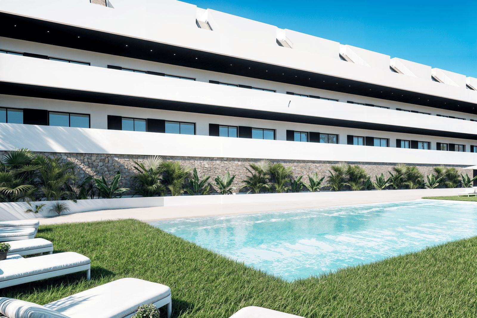 Exterior view of a pool and landscaping surrounding a 2-bedroom penthouse in Finestrat - The Estates